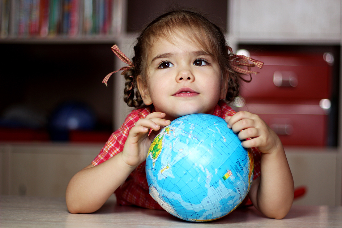 Portrait of the cute little girl hugging the earth globe, save the earth concept